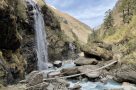 Suspension bridge and waterfall in Miristi Khola Canyon