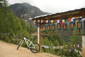 Prayer wheels and view of Tiger's Nest Monastery
