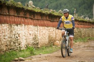 Cycling past mani wall in the Paro Valley
